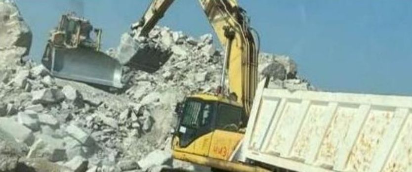 Excavator and dump truck on road works